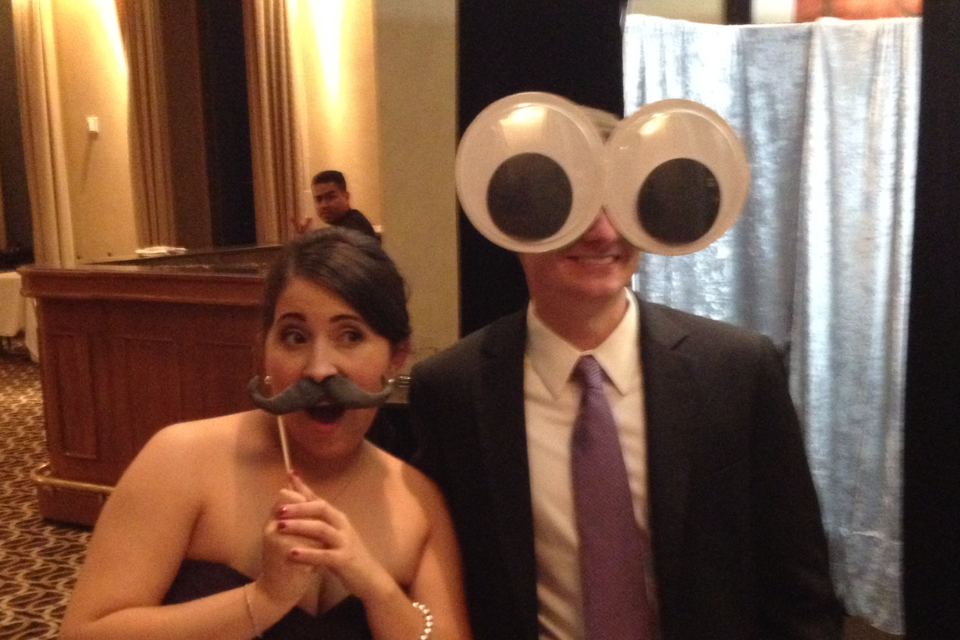 Man has huge googely eyes and his date has a mustache