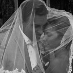 Brides veil swept over both of them
