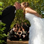 wedding party watch as they kiss
