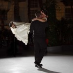 man has his new wife in his arms giving her a kiss