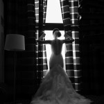 bride in her dress getting ready for the big day looking away from the photographer