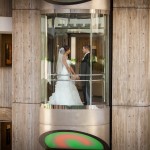 bride and groom holding hands in front of photographer